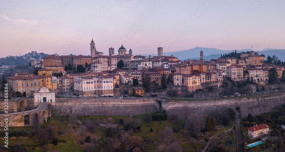 Bergamo, Italy. Drone aerial view of the old town during sunrise. Landscape at the city center, its historical buildings and the Venetian walls a Unesco world heritage