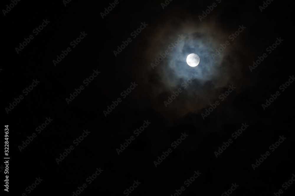 moon through dramatic clouds moon through dramatic clouds