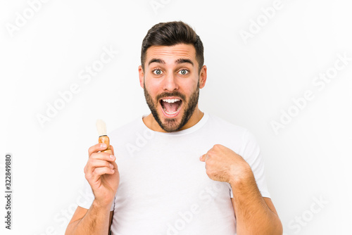 Young caucasian man recently shaving isolated surprised pointing at himself  smiling broadly.