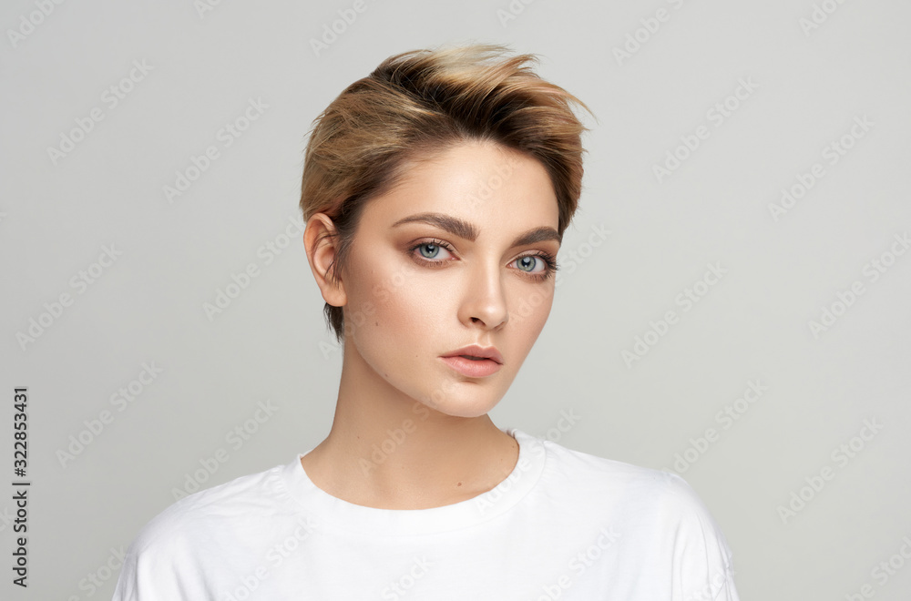 Portrait of young model with short hair isolated on gray background Portrait of young model with short hair isolated on gray background