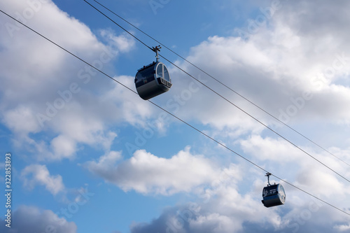 Two cabins of cableway on a background of blue sky on a clear day
