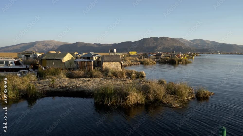 Traditional Uros floating reed islands on Lake Titicaca in the Andes Mountains at the border between Peru and Bolivia Traditional Uros floating reed islands on Lake Titicaca in the Andes Mountains at the border between Peru and Bolivia
