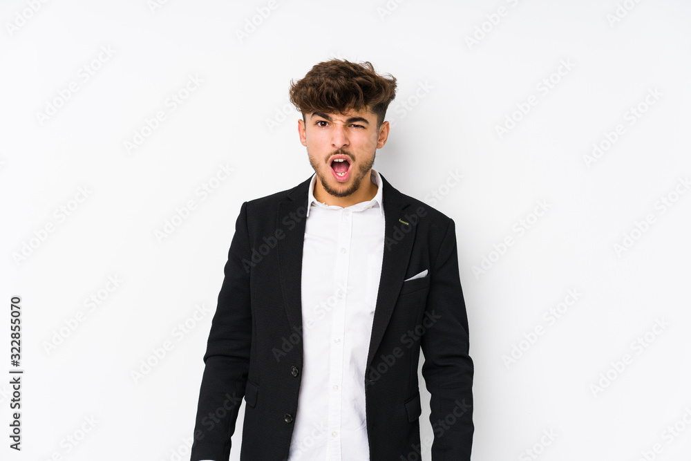 Young arabian business man isolated screaming very angry and aggressive. Young arabian business man isolated screaming very angry and aggressive.