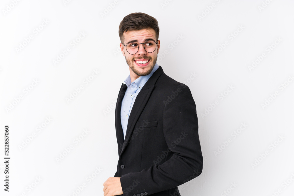 Young caucasian business man posing in a white background isolated Young caucasian business man looks aside smiling, cheerful and pleasant. Young caucasian business man posing in a white background isolated Young caucasian business man looks aside smiling, cheerful and pleasant.