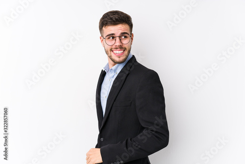 Young caucasian business man posing in a white background isolated Young caucasian business man looks aside smiling, cheerful and pleasant.