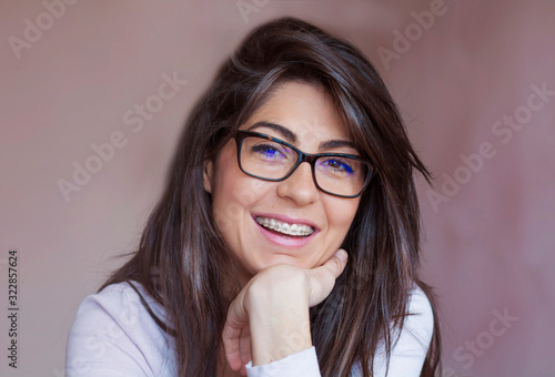 Portrait of a Beautiful Woman with Braces on Teeth. Orthodontic Treatment. Dental Care Concept