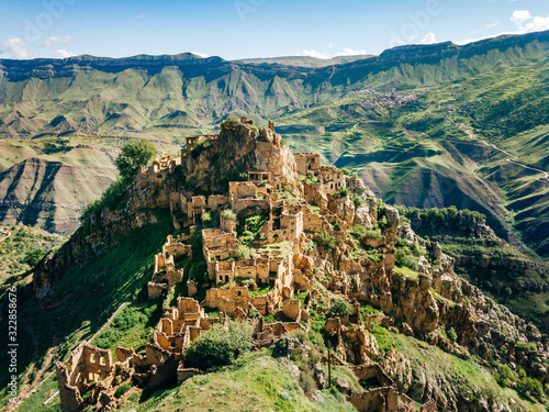 Gamsutl village in Caucasus Mountains. Old stone buildings on top of rock. Summer morning landscape in Dagestan, Russia