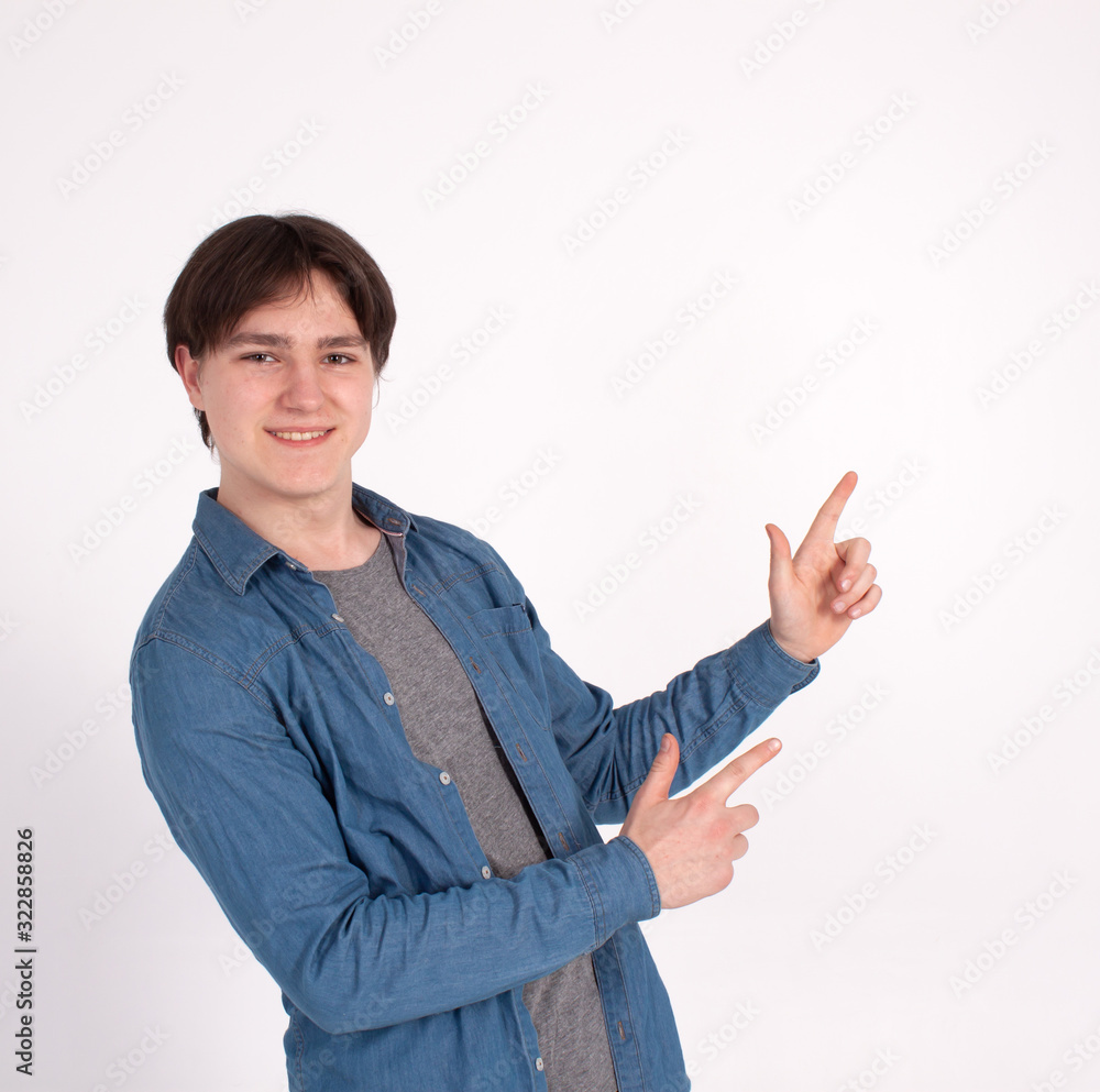 young man nerd pointing finger aside at blank copy space, isolated on white grey studio background. young man nerd pointing finger aside at blank copy space, isolated on white grey studio background.