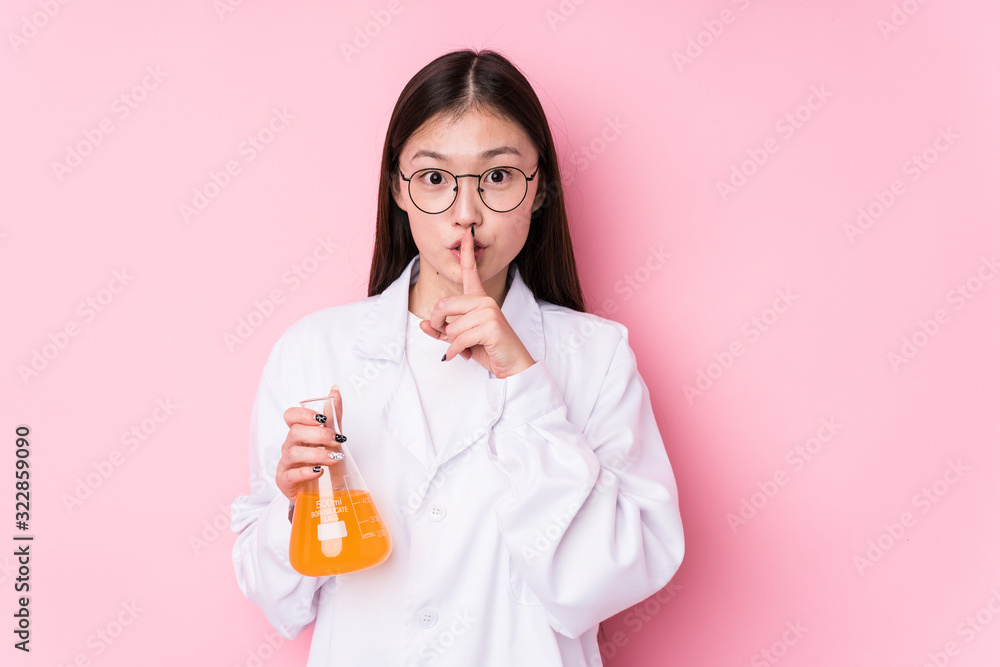 Young chinese scientific woman isolated keeping a secret or asking for silence. Young chinese scientific woman isolated keeping a secret or asking for silence.
