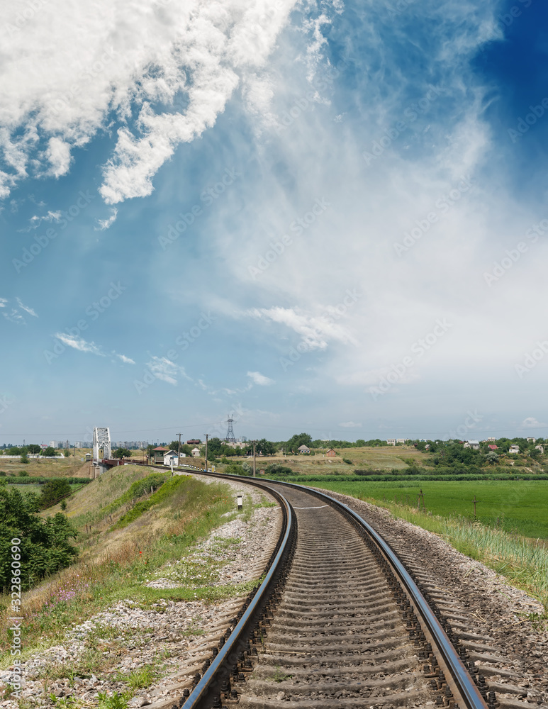 Fototapeta premium rail road to horizon in bridge and blue sky with clouds