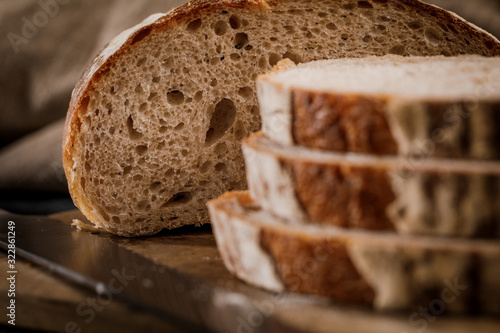 Freshly baked bread cut into chunks on a wooden Board