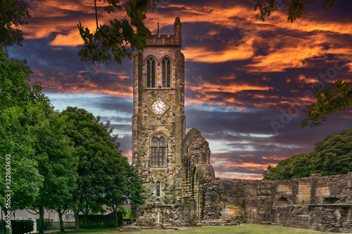 The Old Clock Tower Ruins at KIlwinning Abbey at the end of the day in front of a dramatic red Sky. photo