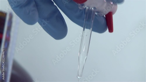 scientist lab opening stopcock and let liquid drain to erlenmeyer flask