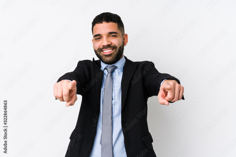 Young latin business woman against a white background isolated cheerful smiles pointing to front. Young latin business woman against a white background isolated cheerful smiles pointing to front.
