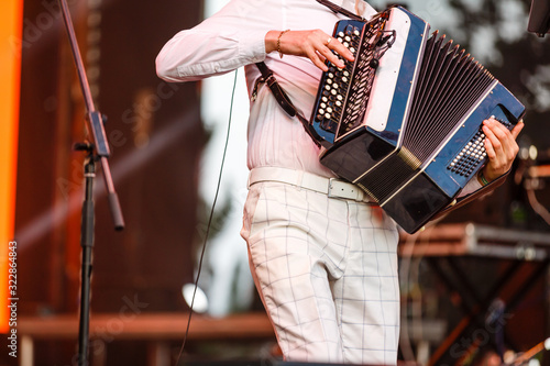 Photos Male playing on the accordion against a grunge background