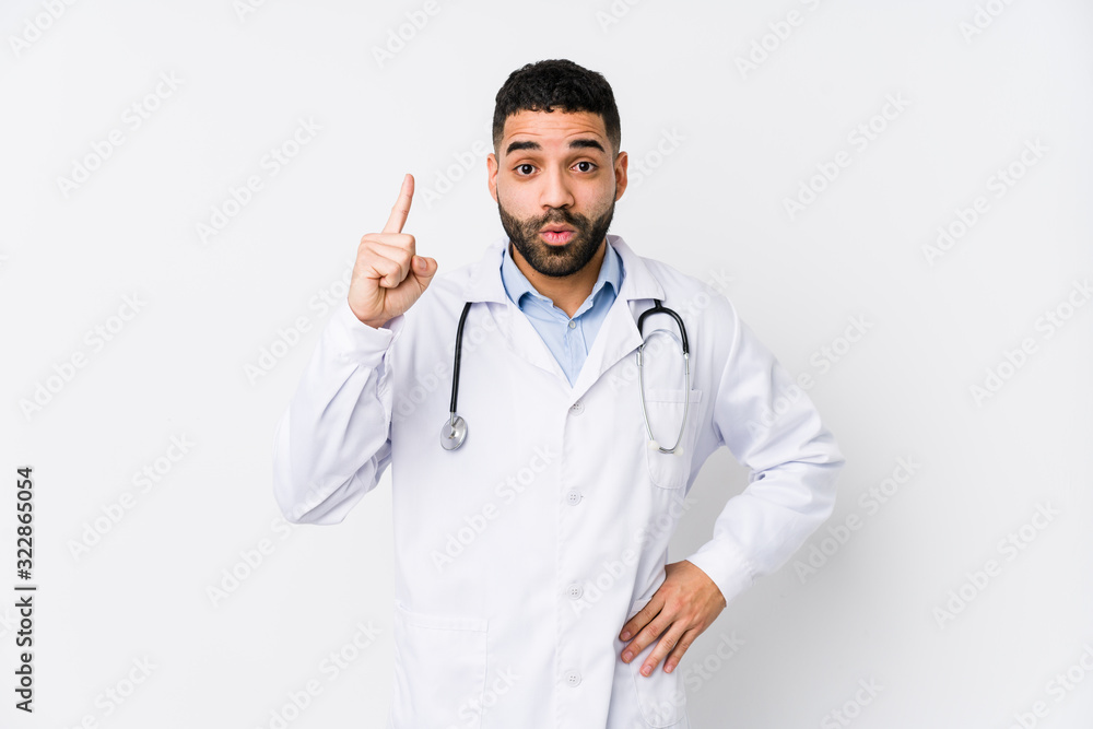 Young arabian doctor man isolated having some great idea, concept of creativity. Young arabian doctor man isolated having some great idea, concept of creativity.