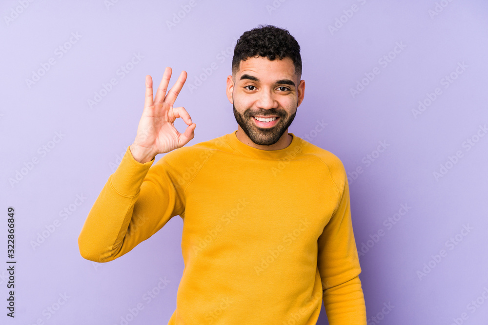 Young mixed race arabic man isolated cheerful and confident showing ok gesture. Young mixed race arabic man isolated cheerful and confident showing ok gesture.