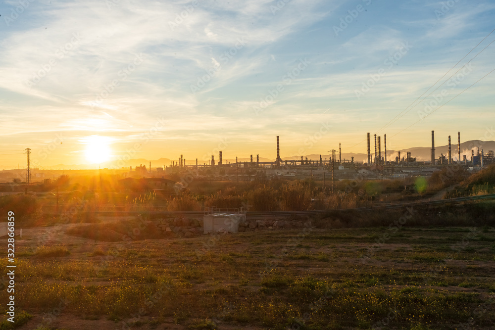 oil refinery at sunset