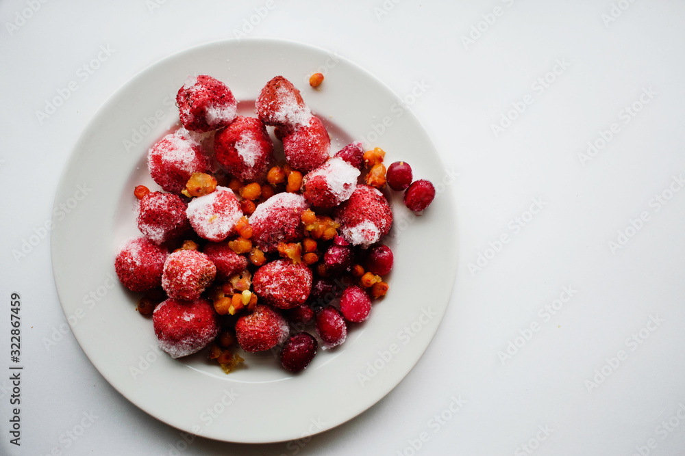 frozen berries strawberries sea buckthorn cranberries in a white plate frozen berries strawberries sea buckthorn cranberries in a white plate