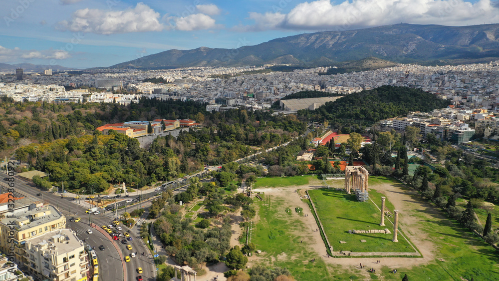 Aerial drone photo of famous column ruins of Temple of Zeus in the slopes of Acropolis hill and the Parthenon, Athens, Attica, Greece