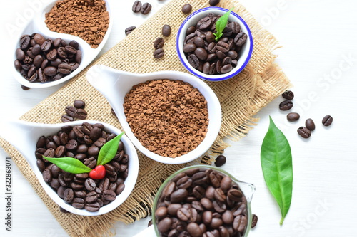 Coffee beans, accompanied by processed coffee powder