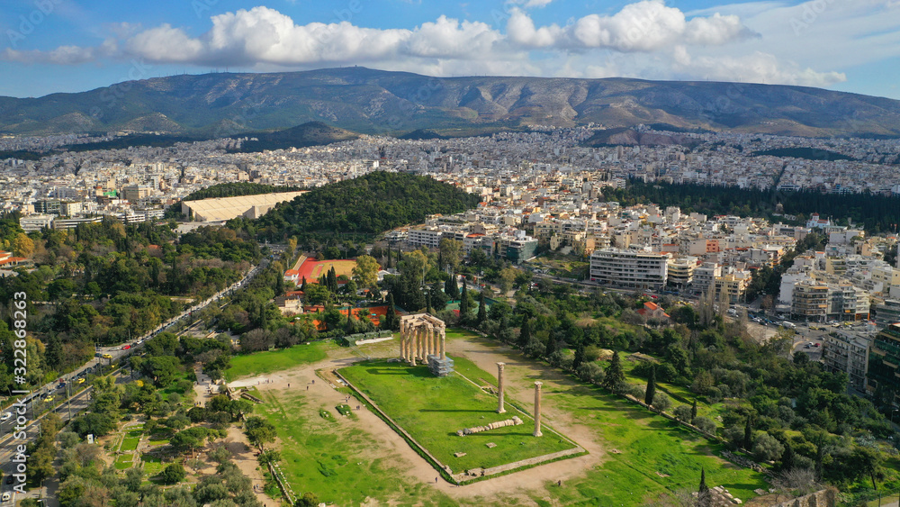 Aerial drone photo of famous column ruins of Temple of Zeus in the slopes of Acropolis hill and the Parthenon, Athens, Attica, Greece
