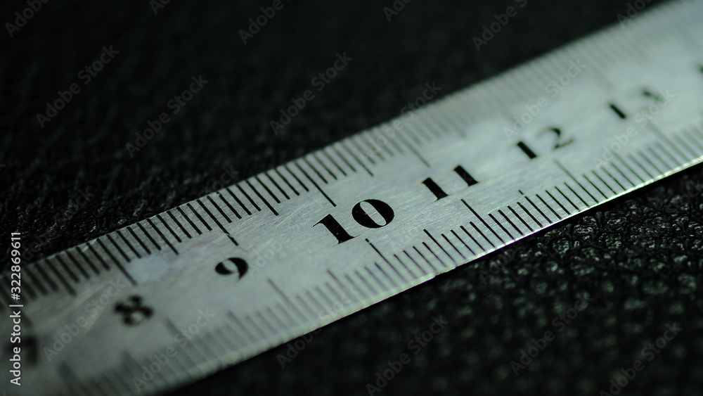 Metal ruler on a black background with a clear number 10 Metal ruler on a black background with a clear number 10