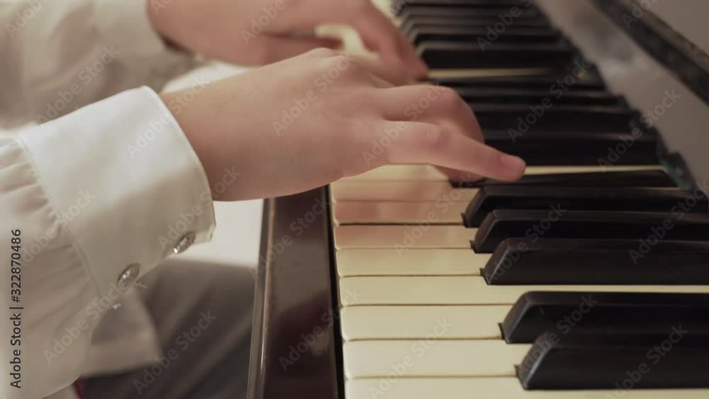 closeup of a young girl hands playing old piano closeup of a young girl hands playing old piano