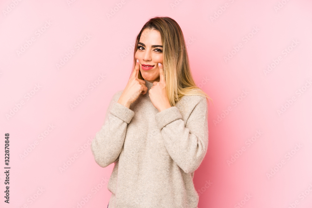Middle age woman over isolated background doubting between two options. Middle age woman over isolated background doubting between two options.