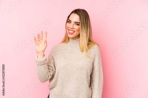 Middle age woman over isolated background smiling cheerful showing number five with fingers.