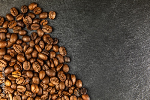 Coffee beans on slate plate. Growing coffee. Fresh coffee beans. Traditional hot drink. Fair trade. © martinfredy