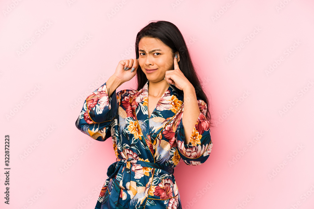 Young chinese woman wearing a asiatic pijama isolated having some great idea, concept of creativity. Young chinese woman wearing a asiatic pijama isolated having some great idea, concept of creativity.