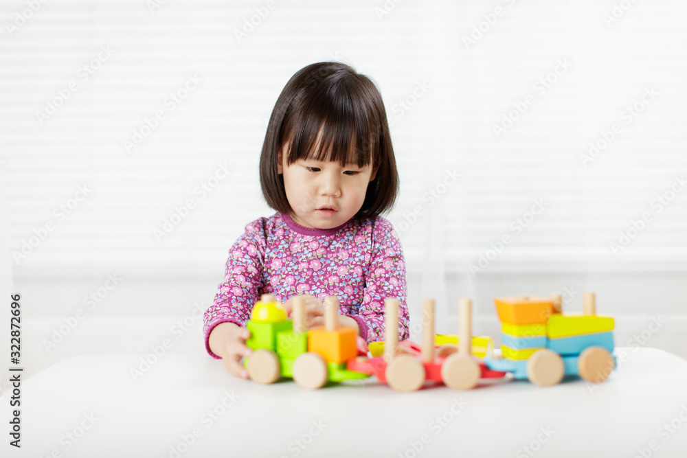 toddler girl playing creative toy blocks at home against white background toddler girl playing creative toy blocks at home against white background