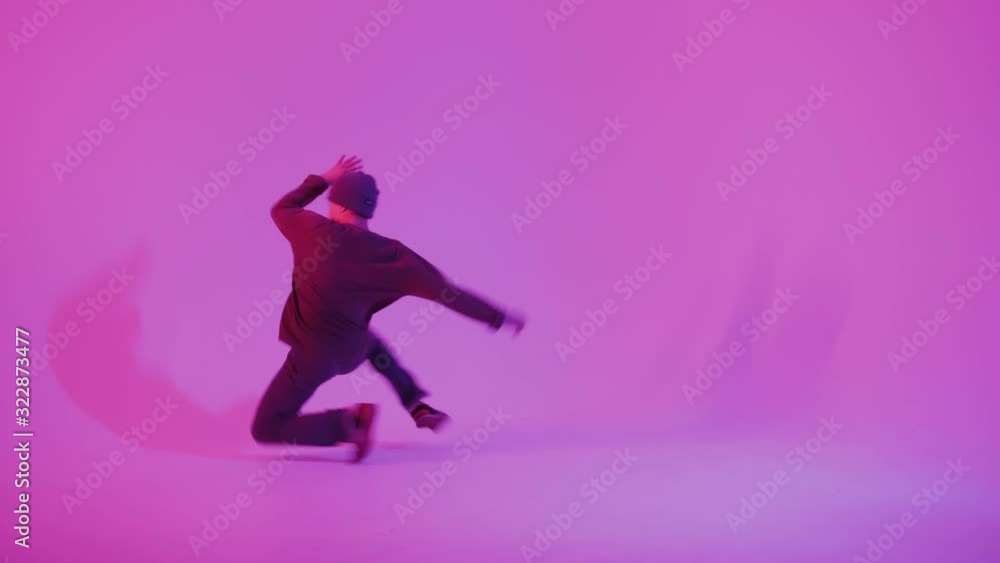 Young Man in a Jumper Dancing Contemporary Dance in Studio. Breakdancing. Dance School Poster. Copy Space. Battle competition announcement. Pink and Blue Background. Young Man in a Jumper Dancing Contemporary Dance in Studio. Breakdancing. Dance School Poster. Copy Space. Battle competition announcement. Pink and Blue Background.