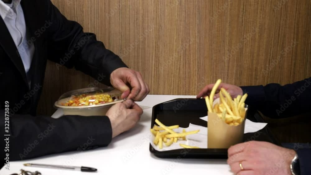 Healthy eating concept. healthy food or junk food. close-up. an attractive bearded man chooses between a health food or a junk food Healthy eating concept. healthy food or junk food. close-up. an attractive bearded man chooses between a health food or a junk food