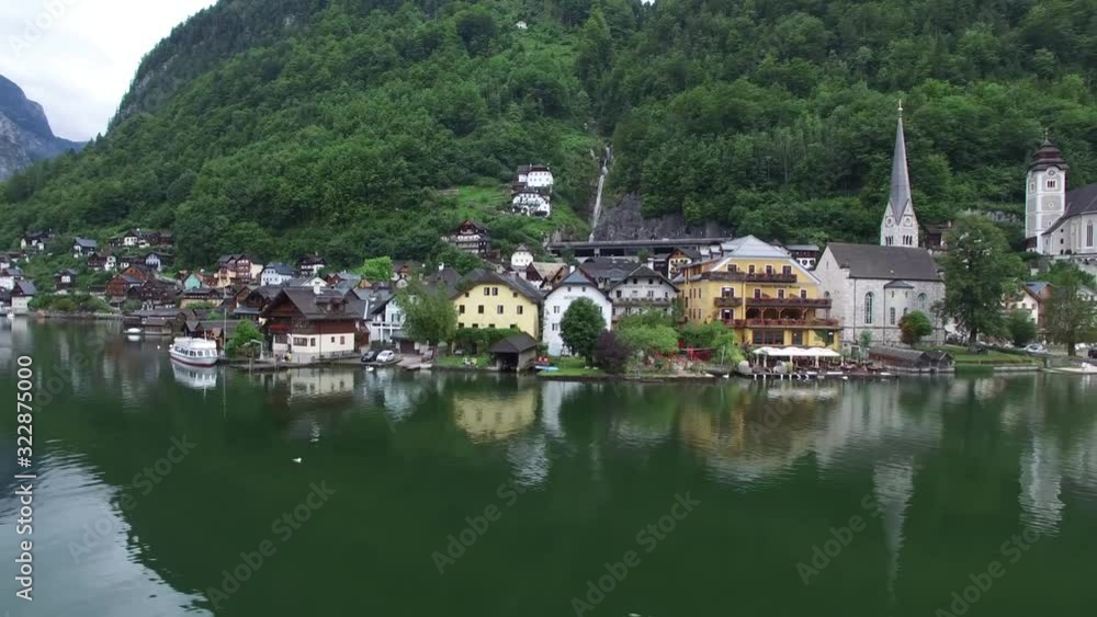 Impressive 4k drone aerial flight over ancient house mirror surface lake beach in wild nature mountain forest landscape Impressive 4k drone aerial flight over ancient house mirror surface lake beach in wild nature mountain forest landscape