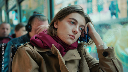 Sick young woman coughs sneezes on the tram cold autumn day flu season disease fever grippe health illness infection influenza migraine sickness slow motion