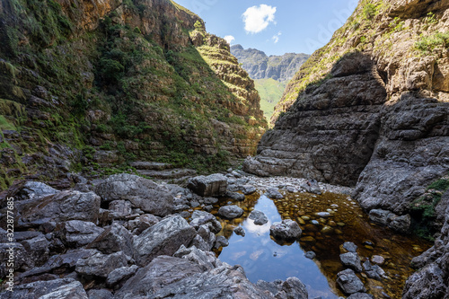 Hiking trail in the Jonkershoek nature reserve into a hidden waterfall, with water and rocks