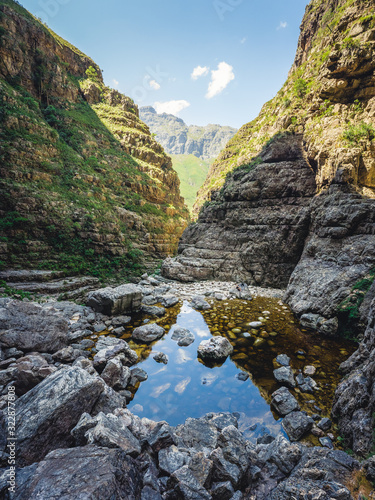 Hiking trail in the Jonkershoek nature reserve into a hidden waterfall, with water and rocks