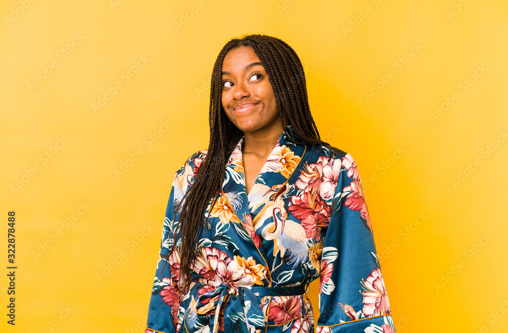 Young african american woman wearing an asiatic pijama isolated dreaming of achieving goals and purposes Young african american woman wearing an asiatic pijama isolated dreaming of achieving goals and purposes