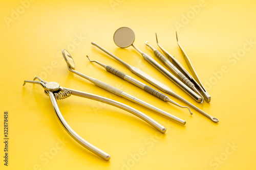 Dental instruments - set with mirrors - on yellow background close up