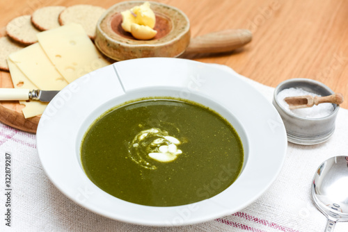 Bowl of spinach soup with a swirl of cream healthy food starter or main meal