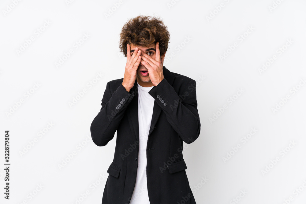 Young caucasian business man against a white background isolated blink through fingers frightened and nervous. Young caucasian business man against a white background isolated blink through fingers frightened and nervous.