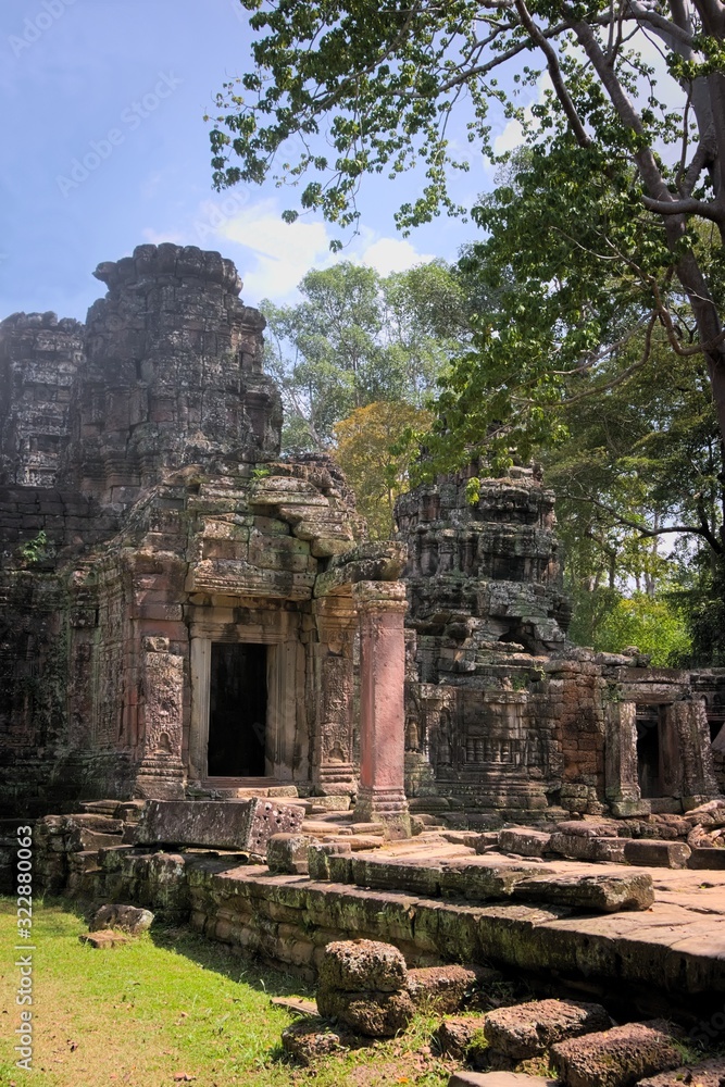 Facade and main entrance to the ruins of Ta Prohm temple, located in Angkor Wat complex near Siem Reap, Cambodia.