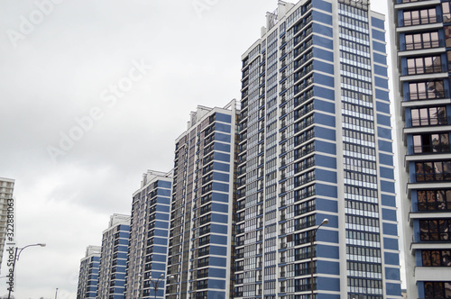 New modern tall blue glass multi-storey comfortable urban monolithic frame houses buildings skyscrapers new buildings in the big city of the megalopolis