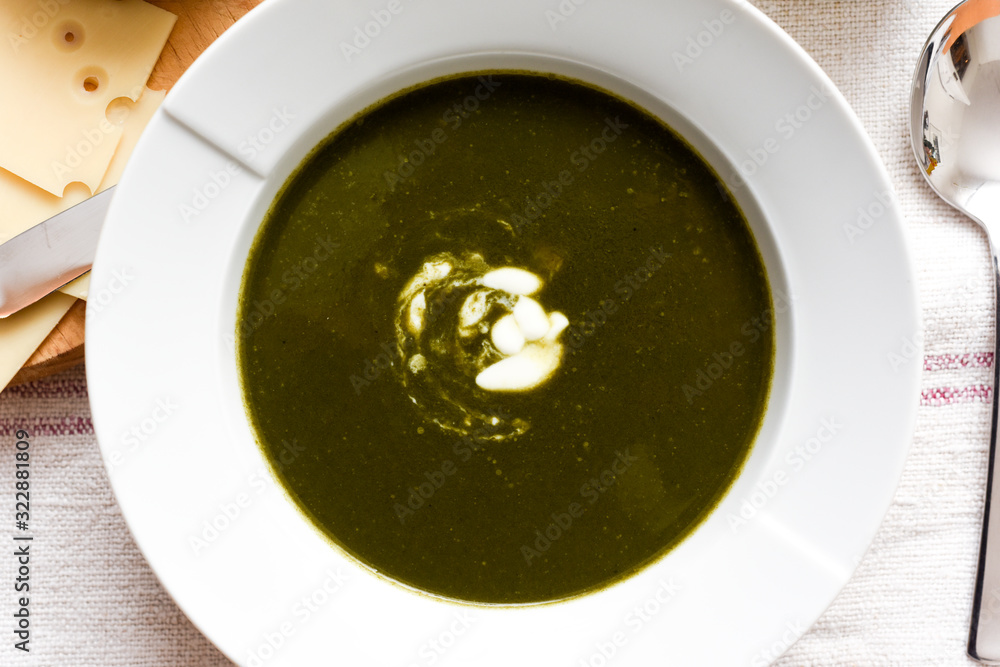 Bowl of spinach soup with a swirl of cream healthy food starter or main meal Bowl of spinach soup with a swirl of cream healthy food starter or main meal