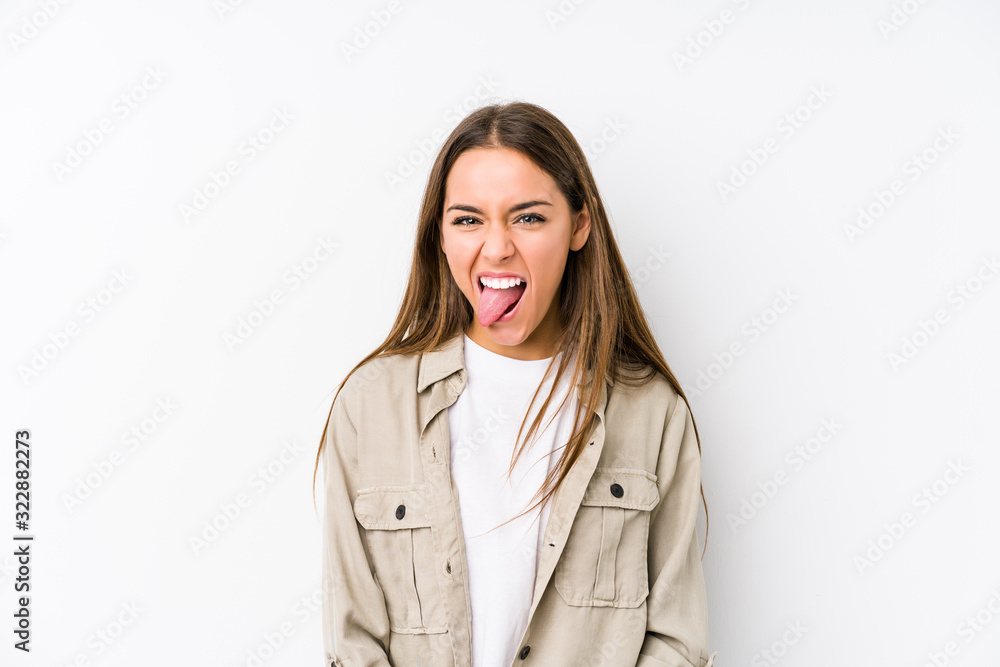 Young caucasian woman isolated funny and friendly sticking out tongue. Young caucasian woman isolated funny and friendly sticking out tongue.