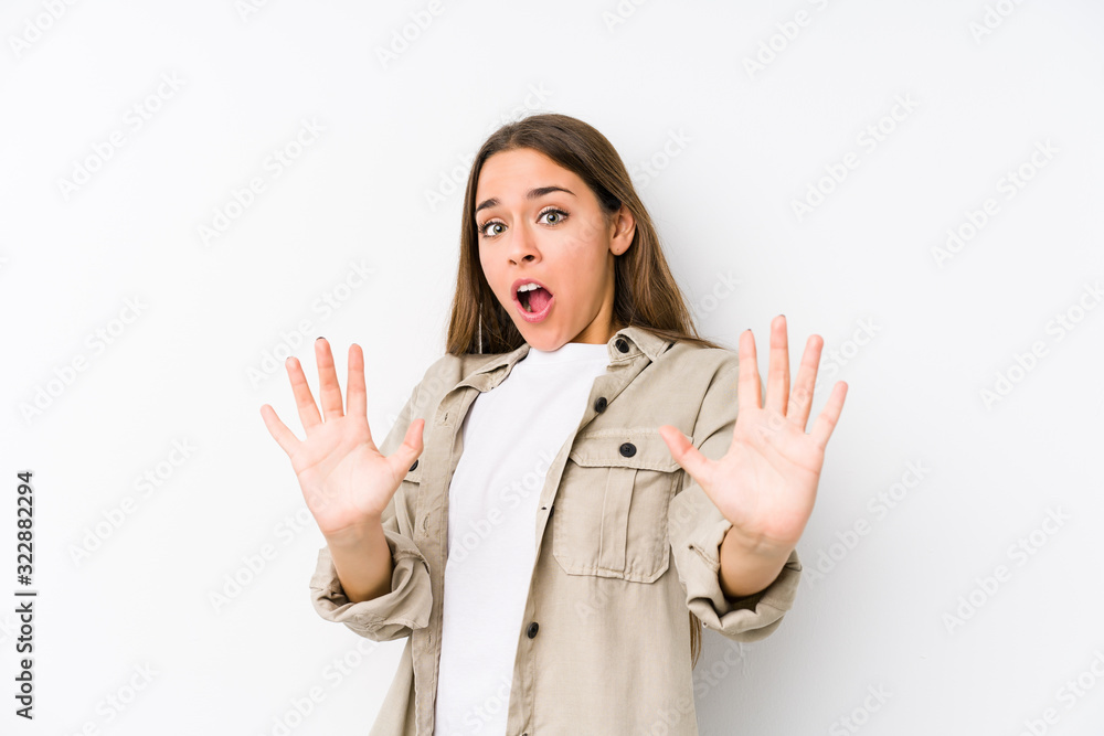 Young caucasian woman isolated being shocked due to an imminent danger Young caucasian woman isolated being shocked due to an imminent danger