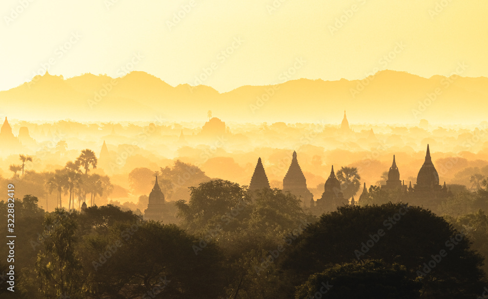 Scenic misty sunrise over Bagan in Myanmar. Bagan is an ancient city with thousands of historic buddhist temples and stupas.