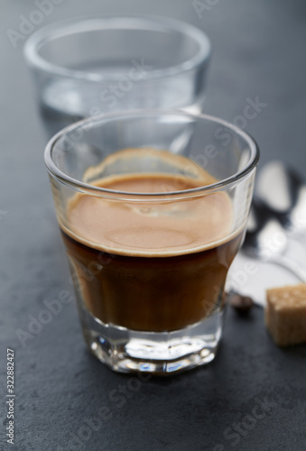 Coffee with milk on dark stone background. Close up.